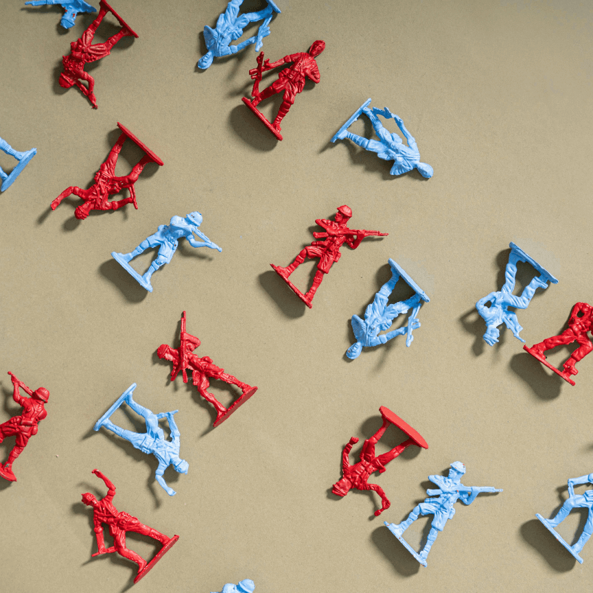 blue and red plastic toy soldiers scattered on a beige floor